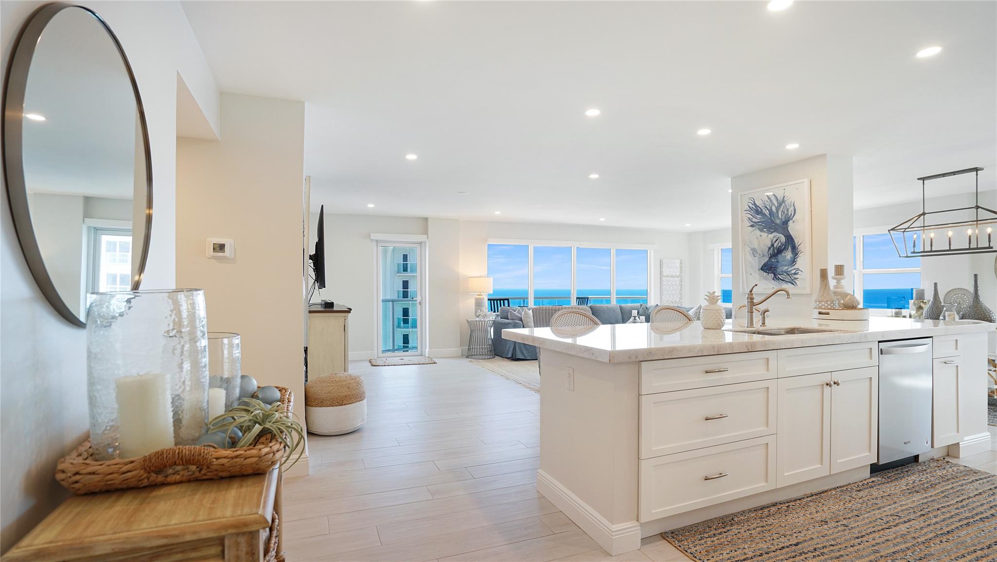 Oceanfront elegance & coastal living. Rarely available updated northeast oceanfront corner unit with stunning 21st floor ocean, intracoastal, city & pool deck views set right on the sand. The open concept layout pairs coastal elegance with modern comfort. This 2 bedroom, 2.5 bath turnkey home features a coastal design throughout. Enjoy entertaining in the beautiful open kitchen. The large primary bedroom has an ensuite bath. Other features include a full size washer/dryer, electric shades & impact windows. Two assigned under building parking spots. Enjoy a resort like lifestyle with amenities including an upcoming beautiful new pool & pool deck, (under renovation)gyms, tennis, lower deck with bbq, private beach access & 24/7 security. Enjoy dining, shopping, and nightlife just minutes away