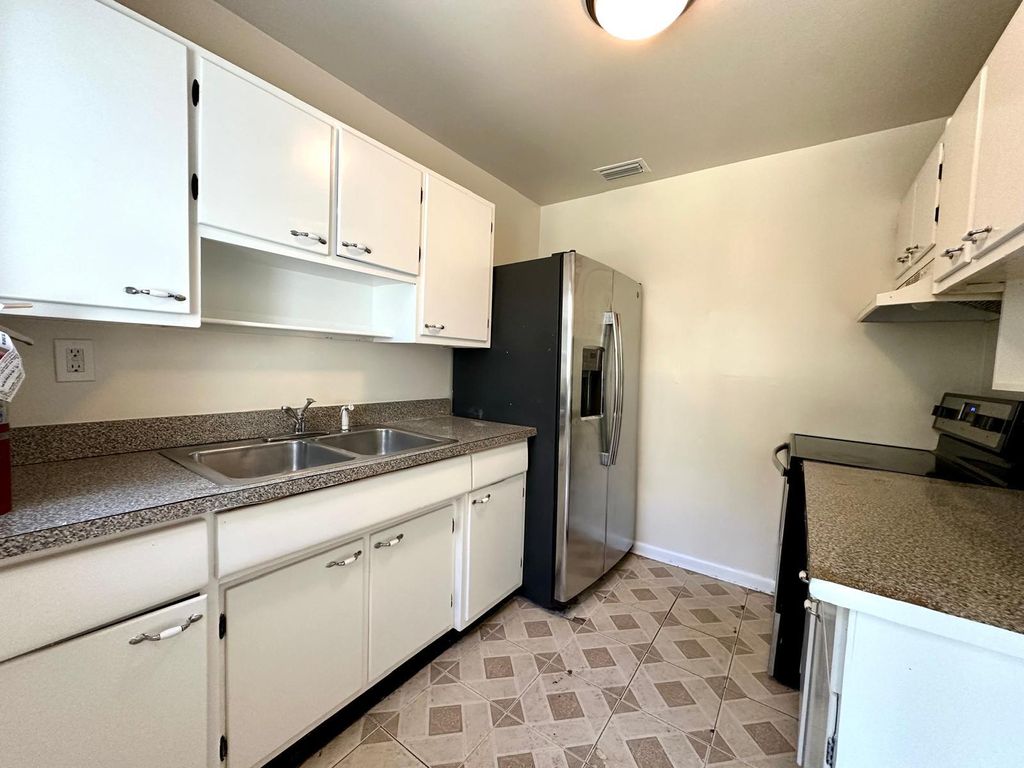 Photo of 861 W Ilex Drive, Lake Park, FL 33403 (MLS # R10982309)