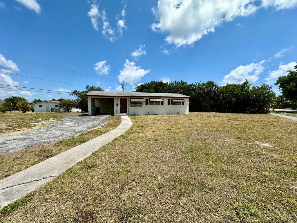 Photo of 861 W Ilex Drive, Lake Park, FL 33403 (MLS # R10982309)