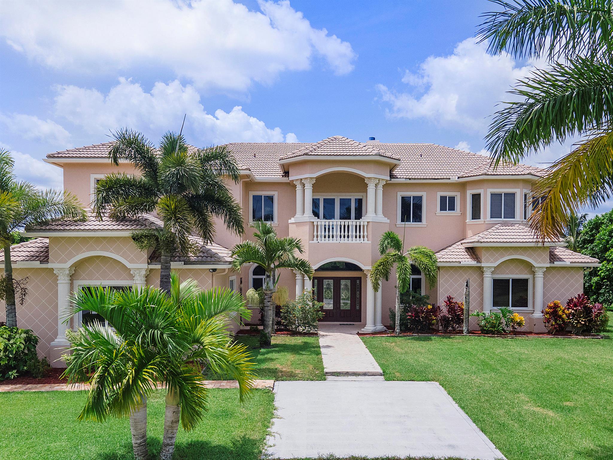 A once-in-a-lifetime opportunity to own a spectacular estate in the prestigious, gated Deer Run equestrian community, just 15 minutes from Wellington's world-class equestrian venues and polo grounds. Set on 5 pristine acres, this opulent 5-bedroom, 5.5-bath residence boasts soaring 28-ft ceilings, a grand stone fireplace, private elevator, and a state-of-the-art home theater. The chef's gourmet kitchen flows into an expansive living space, ideal for grand entertaining. Outdoors, indulge in an oasis resort-style pool, spa, outdoor kitchen, and lush fruit groves with 10 mango trees. Includes a 433 sq. ft. storage shed and plenty room for planned 6-stall barn. Equestrian-friendly, ultra-private, and truly one-of-a-kind. Don't miss this rare opportunity--schedule your private showing today
