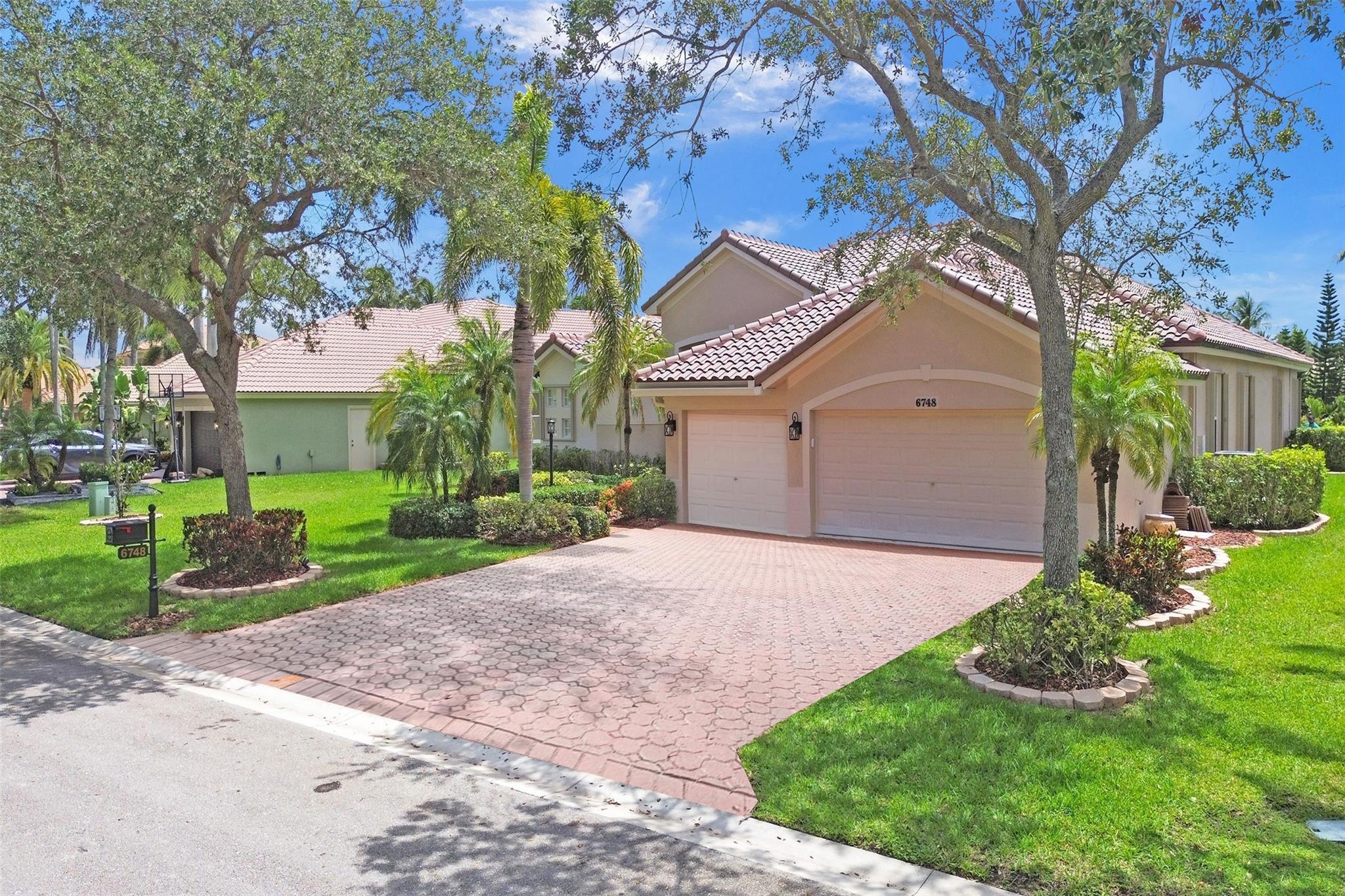 Welcome to your tropical lakefront paradise in Parkland Isles Bayside Estates! This stunning 5-bedroom,3 bath triple split pool home features a brand-new 2025 tile roof, renovated kitchen and baths, a saltwater freeform pool, and a spacious screened patio perfect for entertaining. Enjoy a 3-car epoxy-floor garage with pull-down attic stairs, lush landscaping, crown molding throughout, accordion shutters, and newer dual-zone A/C units(both under 5 years old).Modern upgrades include USB outlets in every bedroom,2023 Nest smart thermostats, smart irrigation, reverse osmosis, and whole-house carbon water filtration covers ADT security, high-speed internet, and cable. Located just a short walk to A-rated schools Park Trails, West Glades, and Stoneman Douglas this is South Florida living at