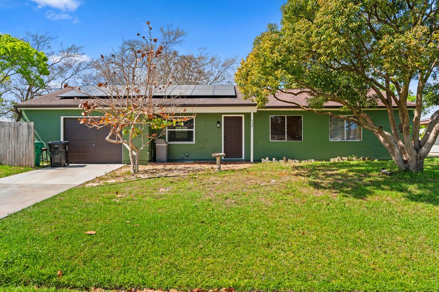 Welcome to this well-maintained 2-bedroom, 2-bath home situated on an .23-acre lot in a highly sought-after area of Port St. Lucie. Offering 1,356 sq. ft. of living space and nearly 2,000 total sq. ft., this property provides comfort, functionality, and plenty of potential.  The home features an updated kitchen with modern touches, complemented by newer appliances and a newer A/C system—key improvements that add everyday convenience and peace of mind. The roof was replaced in 2016, further enhancing the home's overall value. A 1+ car garage provides additional storage or workspace flexibility.  A major plus is the solar panel system, which will be fully paid off by the seller at closing and conveyed to the buyer—allowing you to enjoy energy efficiency and savings from day one.