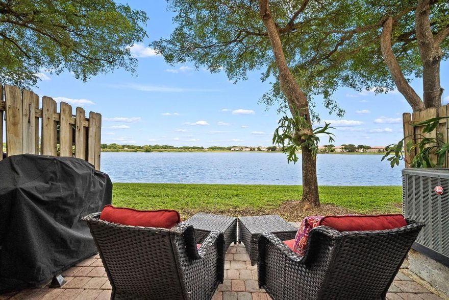 Best lake view in The Shores!!  From the moment you walk in the front door, you know you've found something special. One of the few updated properties currently on the market.  Your beautiful home sits on a serene lakefront, offering peaceful views and a relaxing atmosphere. Freshly painted. Gray wood tiles throughout. Kitchen boasts white cabinets, stainless steel appliances and a quartz countertop. BRAND NEW ROOF, Accordion shutters, and a custom build out under the stairs for extra storage. Appliances and A/C 4 years old.  Two designated parking spots. Come see your new home and you're sure to fall in love!!!