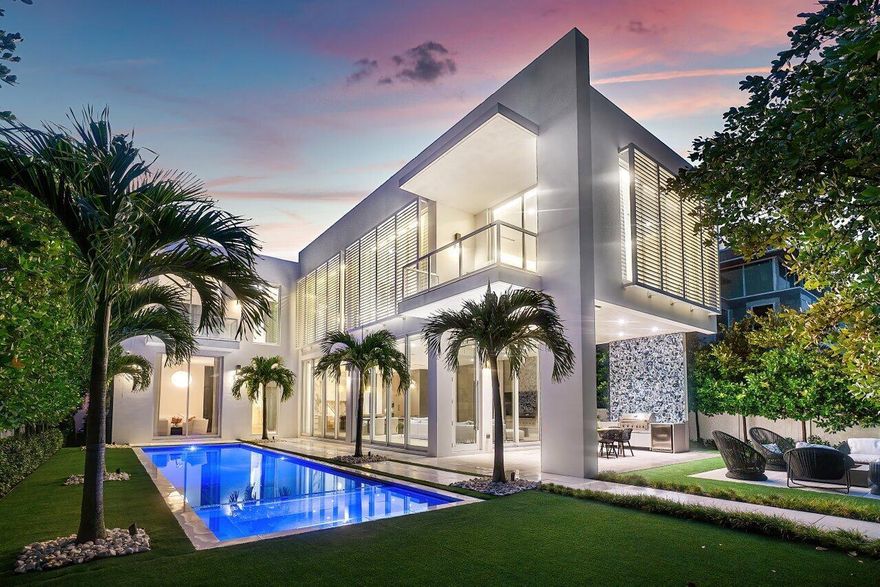 Have you ever wondered what it would be like to have a private resort in the heart of one of South Florida's most esteemed neighborhoods? At 132 NE 7th Avenue in Delray Beach's Palm Trail, tropical fantasy becomes coastal reality. Comprising 6,235 total square feet, 4,778 of which are under air, this vast 2022 construction has 4 bedrooms and 4.1 bathrooms along with a home office, media room, gym/flex area, and so much more to offer the highest level of luxury in a superb location. This organic-modern style home features a private courtyard gated entrance along with a massive 4-car garage that leads directly into a mudroom and powder room. From there, the home expands into its open kitchen and great room, which feature airy 12-foot ceilings and panoramic sliding glass doors that