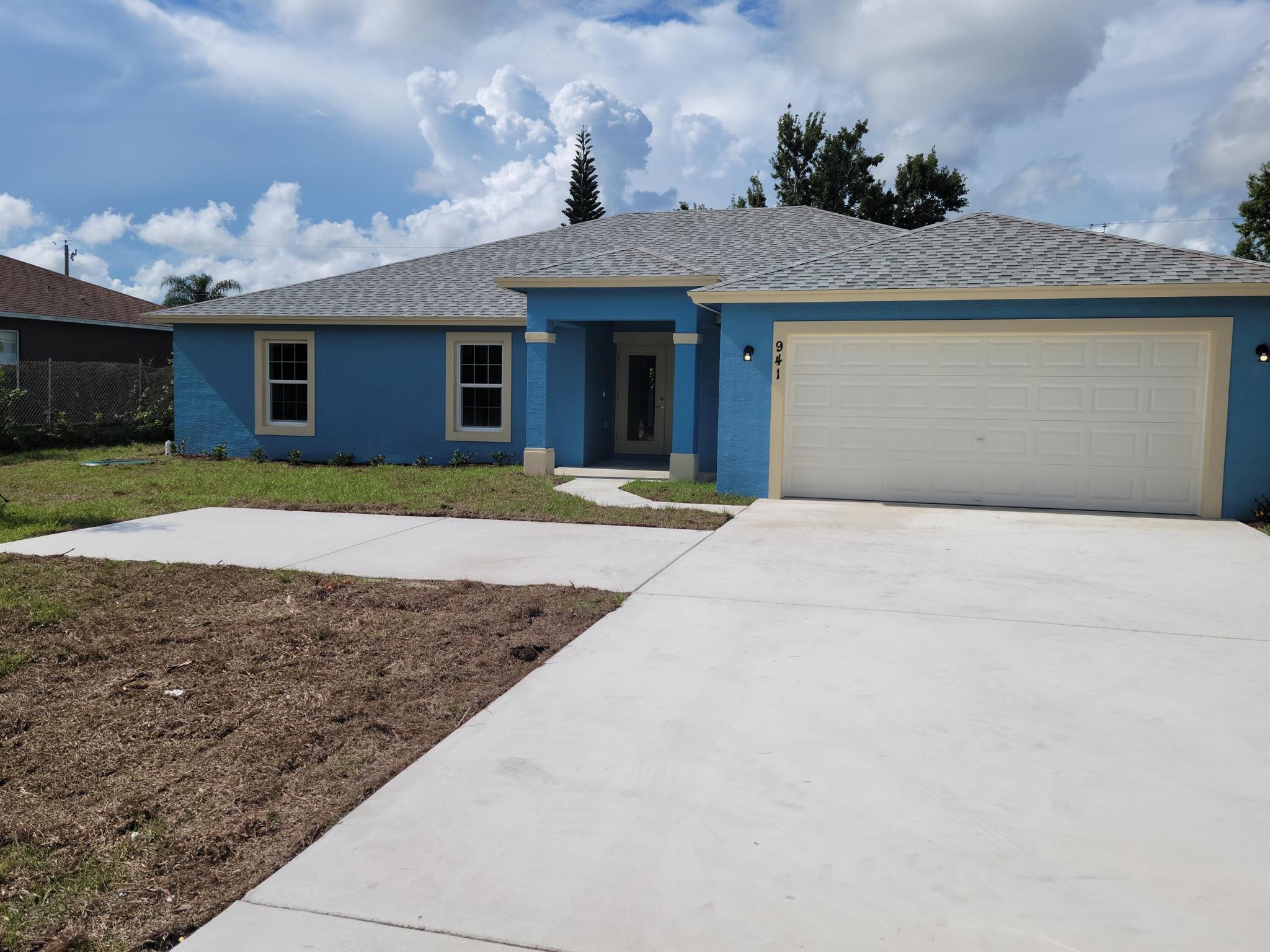 Built in 2022, this newer 4-bedroom, 2-bathroom home offers modern comfort and peace of mind. Featuring tile floors throughout, an open kitchen with breakfast nook, and a spacious great room, the layout is perfect for everyday living and entertaining. Enjoy added convenience with ceiling fans in every room, pre-hung curtain rods, and impact glass windows for enhanced protection during hurricane season. The large screened-in patio overlooks a generous backyard, and lawn care is included. Ideally located near both I-95 and the Florida Turnpike, with shopping, dining, and entertainment just minutes away.