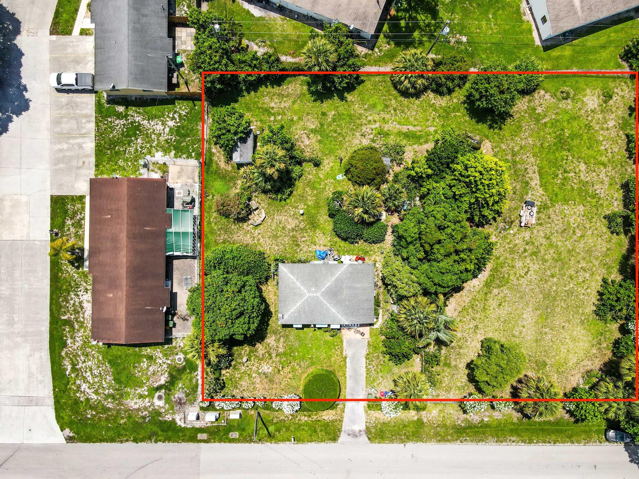 Attention Investors, Developers, and Visionaries! A rare opportunity just hit the market in one of Palm Beach County's most centrally located areas -- Palm Springs! Prepare to discover a tropical paradise perfectly situated on a fully fenced .7 acre lot with two entrances, east-facing within a desirable non-HOA community in Palm Springs, FL. This property offers opportunity to build multiple units - ideal for duplexes, townhomes/homes, or apartments (confirm density with city planning). Preliminary estimates suggest up to 4 units possible, depending on final site plan and city approvals! Established residential area with water, electric, and sewer access on-site on a flat nearly cleared lot.