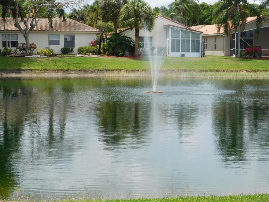 If you have been waiting for a home in The Grove with a GORGEOUS, SPARKLING LAKE VIEW, your wait is over!  This home is the largest and most sought after model in the community!  As you enter through the screened, covered entry, you will be greeted by high vaulted ceilings and an open, spacious layout. Ceramic tile on the diagonal spans the living areas and den. With a FORMAL DINING ROOM, LIVING ROOM, FAMILY ROOM and LARGE SCREENED PATIO, this home is perfect for entertaining! Imagine welcoming the morning in your eat-in kitchen or outside on your enclosed patio while watching the ducks swim by. At night, relax while you gaze at the NIGHTLY ILLUMINATED FOUNTAIN after the sun sets. The dining room is strikingly adorned by custom mirrors and illuminated mirrored alcove. OPEN CONCEPT KITCHEN with lots of storage, pantry, double sink and breakfast bar. The HUGE MASTER BEDROOM features laminate flooring, SITTING AREA and DUAL MIRRORED WALK-IN CLOSETS. LARGE MASTER BATHROOM EN SUITE with DUAL SINKS, VANITY, LARGE SHOWER WITH SEAT, separate ROMAN TUB and WC. Carpeted SECOND BEDROOM with WALK-IN CLOSET. Separate laundry room. NEWER ROOF (10 years old). Sold with furnishings and contents (except family photos in den wall unit and some additional items in the garage and closet). 

The Grove is an active community with a full array of activities from arts & crafts to entertainment, fitness classes, card rooms, clubs, and MORE! The clubhouse was recently renovated and it is SPECTACULAR! The active "Baby Boomers Club" is the envy of neighboring communities. There is an Olympic size swimming pool, tennis and pickleball courts and even a putting green!  EXTERIOR PAINTING, LAWN CARE, EXTERIOR PEST CONTROL and ROOF PRESSURE CLEANING included in the HOA dues. Convenient easy access to the Florida Turnpike and I-95. Close to Bethesda West Hospital, Canyon Town Center and a short drive to the Delray Marketplace. DON'T DELAY! You do not want to miss out on this home!