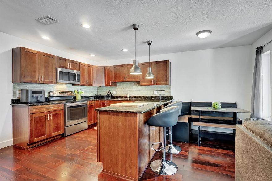 Highly desirable renovated second story unit with coveted water view in Palm Club. 
 Kitchen is open to living space, featuring stainless appliances and granite countertops.  Bathrooms are updated as well.  Primary bedroom suite has a walk-in closet.  Water views from all bedrooms and living room.  Hardwood floors throughout.  Large laundry room with full size washer and dryer and ample space for additional storage.  Close to community amenities including:  tennis, squash, huge pool and community room.  Building is nearby convenient resident-only entrance/exit gate.