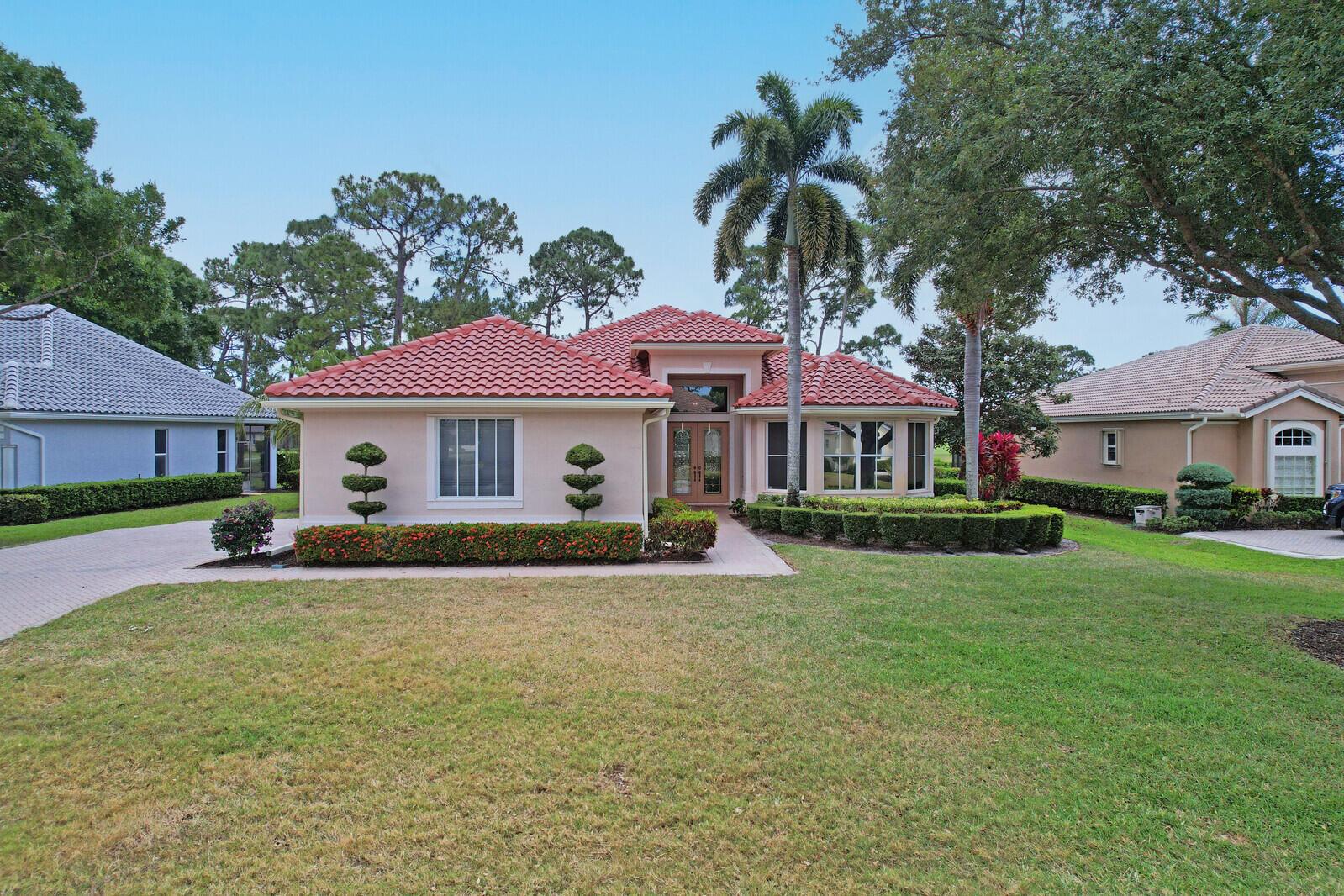 THIS PROPERTY IS A TRUE STANDOUT with an incredible backdrop of sparkling water & lush golf course views! Enjoy resort-style living every day in this beautifully appointed home in the highly sought-after Cypress Point neighborhood in the heart of PGA Village. Meticulously maintained & updated for peace of mind with a new quality roof installed in 2024, newer A/C, water heater, washer/dryer & range along with recently resurfaced inground spa. Inside you will find quality finishes throughout, including porcelain tile flooring, crown molding & a wet bar perfect for entertaining. The spacious extended screened lanai offers a private spa, ample space for outdoor living & room to add a pool. The oversized 2 car garage provides plenty of room for vehicles, a golf cart & includes an electric