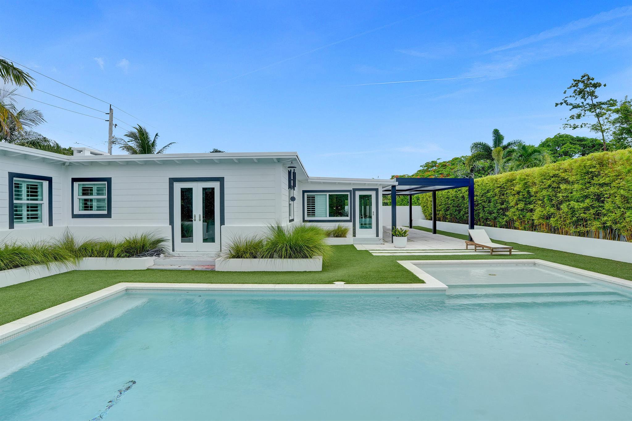 Stunning resort style modern property, bursting with style & character, wood beamed ceilings and decorative fireplace. Just a few blocks from Pineapple Grove Arts district and Atlantic Avenues vibrant nightlife, restaurants & boutiques. Ultimate Indoor, outdoor living with a large pergola for alfresco dining, a 15 x 30ft saltwater pool with heater/chiller & sun shelf, kid friendly artificial turf , outdoor shower and fire pit area where you can enjoy s'mores in the evenings. Fully furnished ready to move in, so you can enjoy the Florida lifestyle.