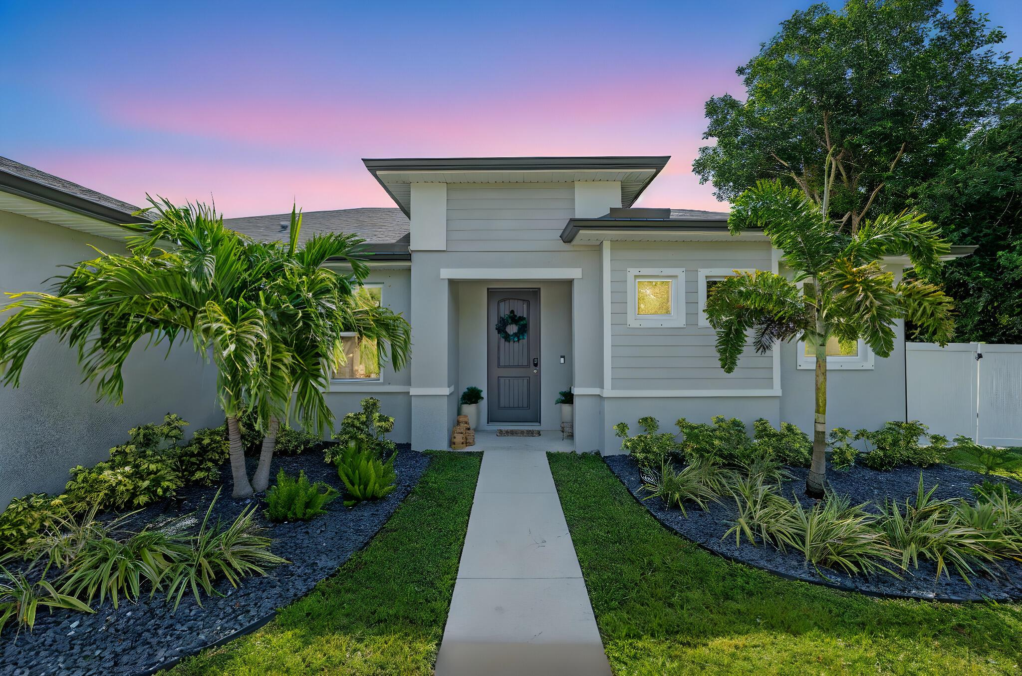 Modern 3-bedroom CBS home with a large flex room that easily functions as a 4th bedroom, office, or guest space. Built in 2022, this spacious 2,039 sq ft home sits on a 1/4-acre lot with no HOA in one of Port St. Lucie's most convenient locations. The open-concept layout features a sleek kitchen that flows into a bright living area, perfect for entertaining or everyday living. The primary suite includes dual walk-in closets and double vanities. Outside, enjoy a fully fenced backyard with turf-lined pavers and a custom designer pergola for low-maintenance outdoor living. Located just minutes from both I-95 and the Turnpike, this property offers easy access to commuting routes while providing space, style, and freedom in a move-in-ready home.