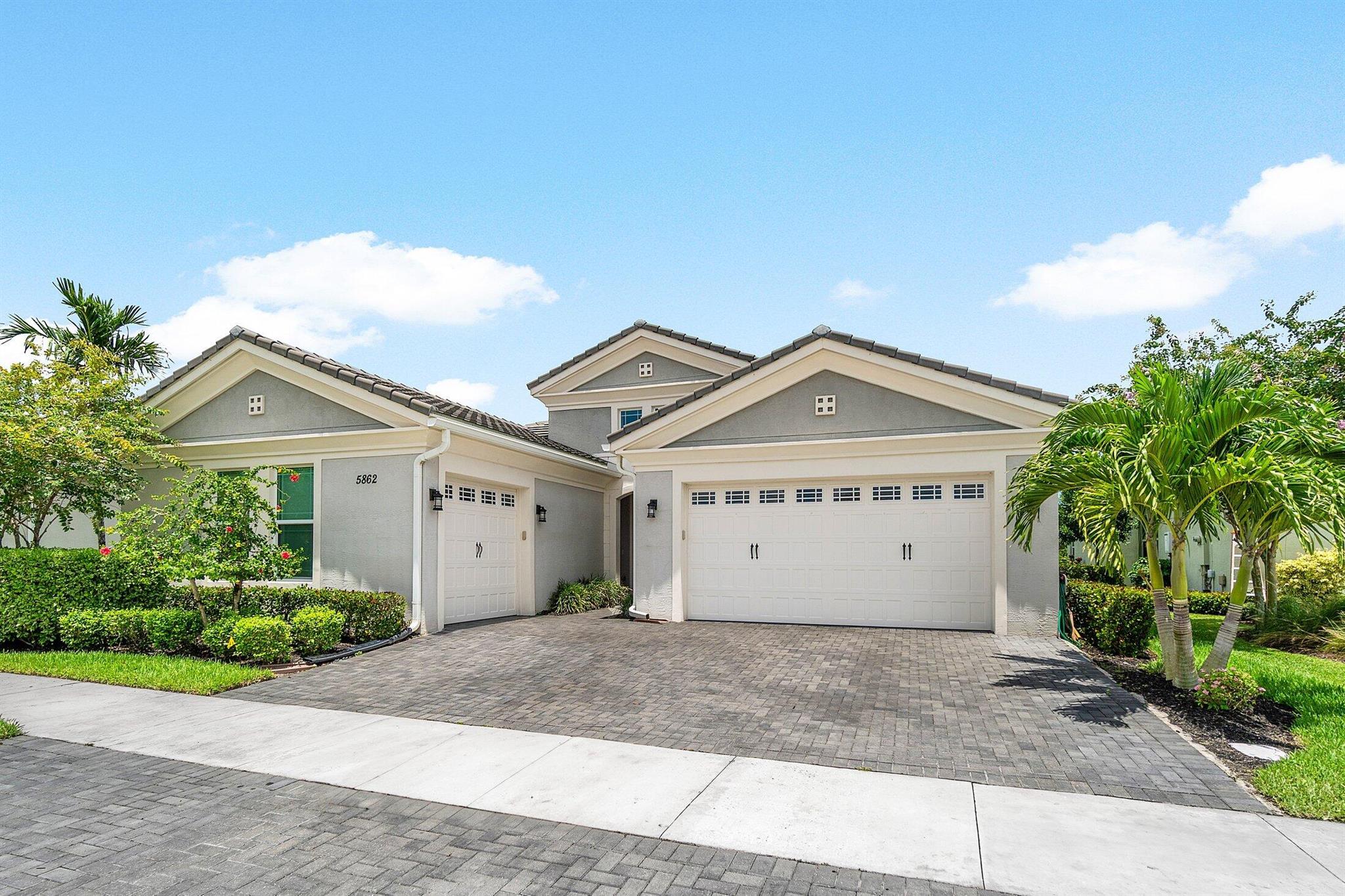 Immaculate Lakefront Home in The Hammocks at Westlake - Built in 2020 Beautifully designed CBS construction featuring 3 bedrooms, 3 bathrooms, and a 3-car garage. An impressive foyer opens to the formal living room and adjacent dining room with a custom built-in buffet, conveniently located next to the chef's kitchen that showcases white cabinetry, stainless steel appliances, and granite countertops, opening to casual dining and the family room with stunning views of lush landscaped yard w/lake views. The secluded master suite offers serene water vistas, two custom walk-in closets, and a large, well-appointed bathroom. Two additional bedrooms are located off a private hallway with a den featuring a custom built-in cabinet with fridge and microwave--previously set up with a barn door..