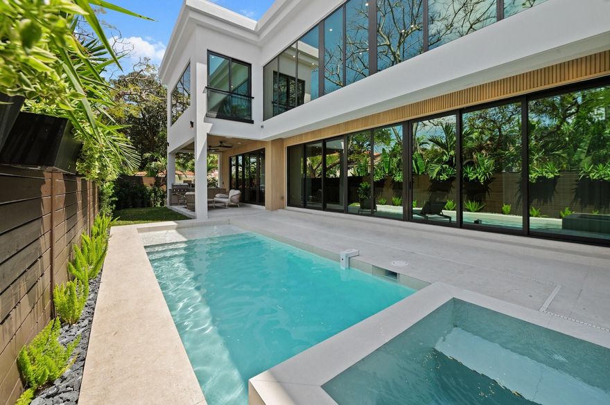 This custom built two story contemporary luxury masterpiece in the heart of Victoria Park boasts an impressive open floor plan on the entry level with over 10 FT floor-to-ceiling windows, tri-folds & doors allowing abundance of natural light. Grand living room with Cathedral ceilings & custom chandeliers. Chef's Paradise kitchen features high-end appliances, Italian cabinetry, huge Island & porcelain countertops. This house is adorned with frameless doors, wood panels, ultra sexy lighting & top of the line interior fixtures which sets a new standard of high-end living in Fort Lauderdale. All bedroom suites are upstairs. Enjoy your private lushly landscaped infinity pool & covered outdoor summer kitchen from every room while transporting you to your own tropical escape. Close in 30 days.