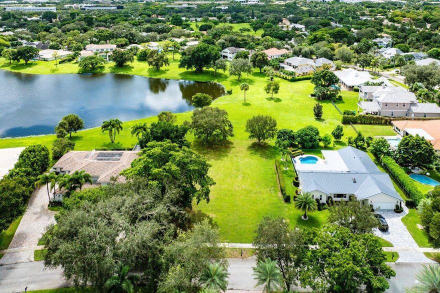 Prime Vacant Lot in Boca Bath & Tennis - A Rare Offering! An extraordinary opportunity awaits in the heart of Boca Bath & Tennis, one of Boca Raton's most coveted and established family communities. This prime 150' x 100' lot is ideally situated with sweeping parkland vistas and tranquil lake views, providing the perfect canvas to design and build a dream estate that reflects your personal vision. Unlike today's new developments with narrow lots and ''cookie-cutter'' layouts, Boca Bath & Tennis is celebrated for its generously sized homesites, spacious open areas, and architectural individuality. Every home is unique, creating a neighborhood rich in character and charm, where privacy and breathing room are the standard--not the exception. For the avid tennis player, this community is truly