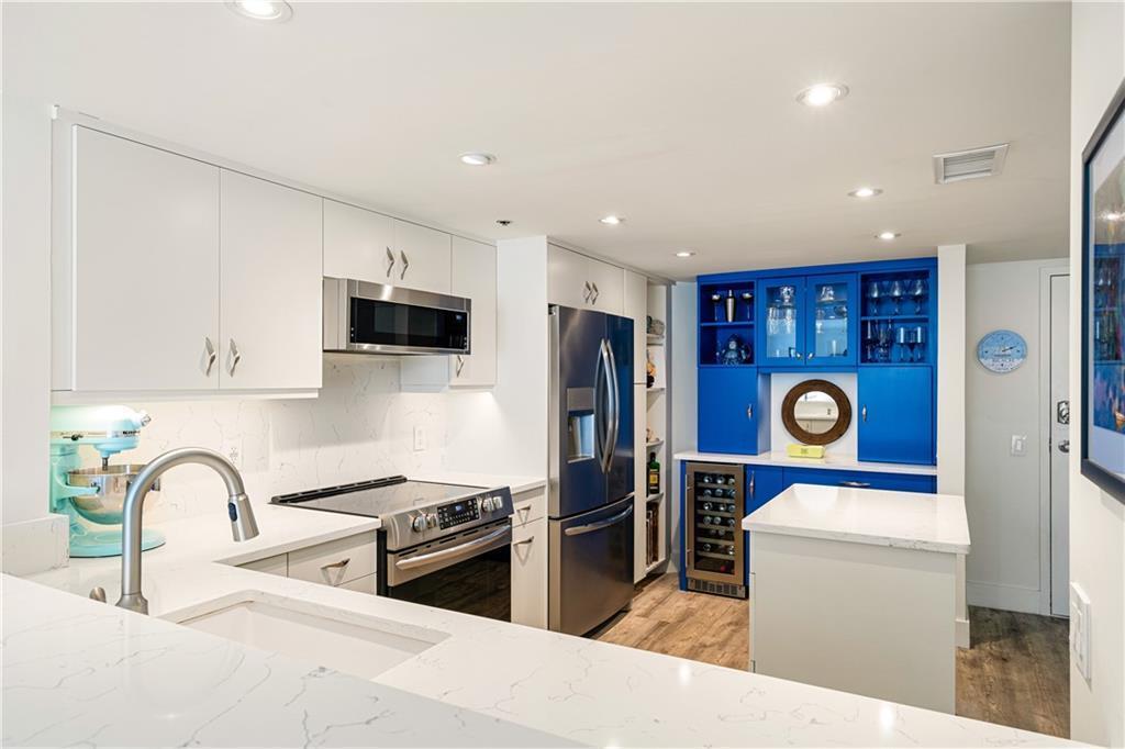 Experience coastal luxury at its finest in this totally renovated Aquanique condo on Hutchinson Island! Enjoy gorgeous ocean views and an open, airy floor plan with elegant finishes throughout. The gourmet kitchen shines with stainless steel appliances, island, quartz countertops, wine/coffee bar, pantry, & glass cabinetry. The primary suite features a walk-in closet & spa-style bath w/ double sinks, quartz countertops & large walk-in shower. The recently renovated building has a new roof. Resort-style amenities: pool, spa, fitness, pickleball, & beach access. This is island living redefined!