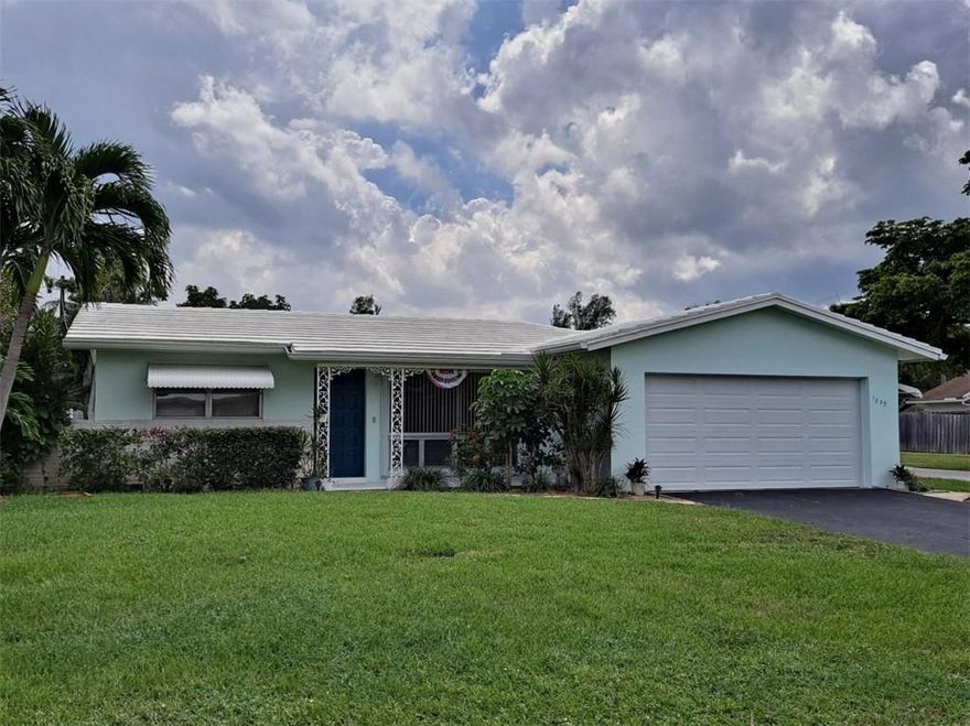 Large 2 bedroom, 2 full bathroom home with an attached 2 car garage. Central A/C, terrazzo floor, Florida Room with fireplace.  Corner lot with side access for an boat or RV trailer.  Large covered rear patio area.  All original home that is comfortable and livable as is, or remodel it to your liking.  No HOA.  Short walk to the Royal Palm park north entrance.