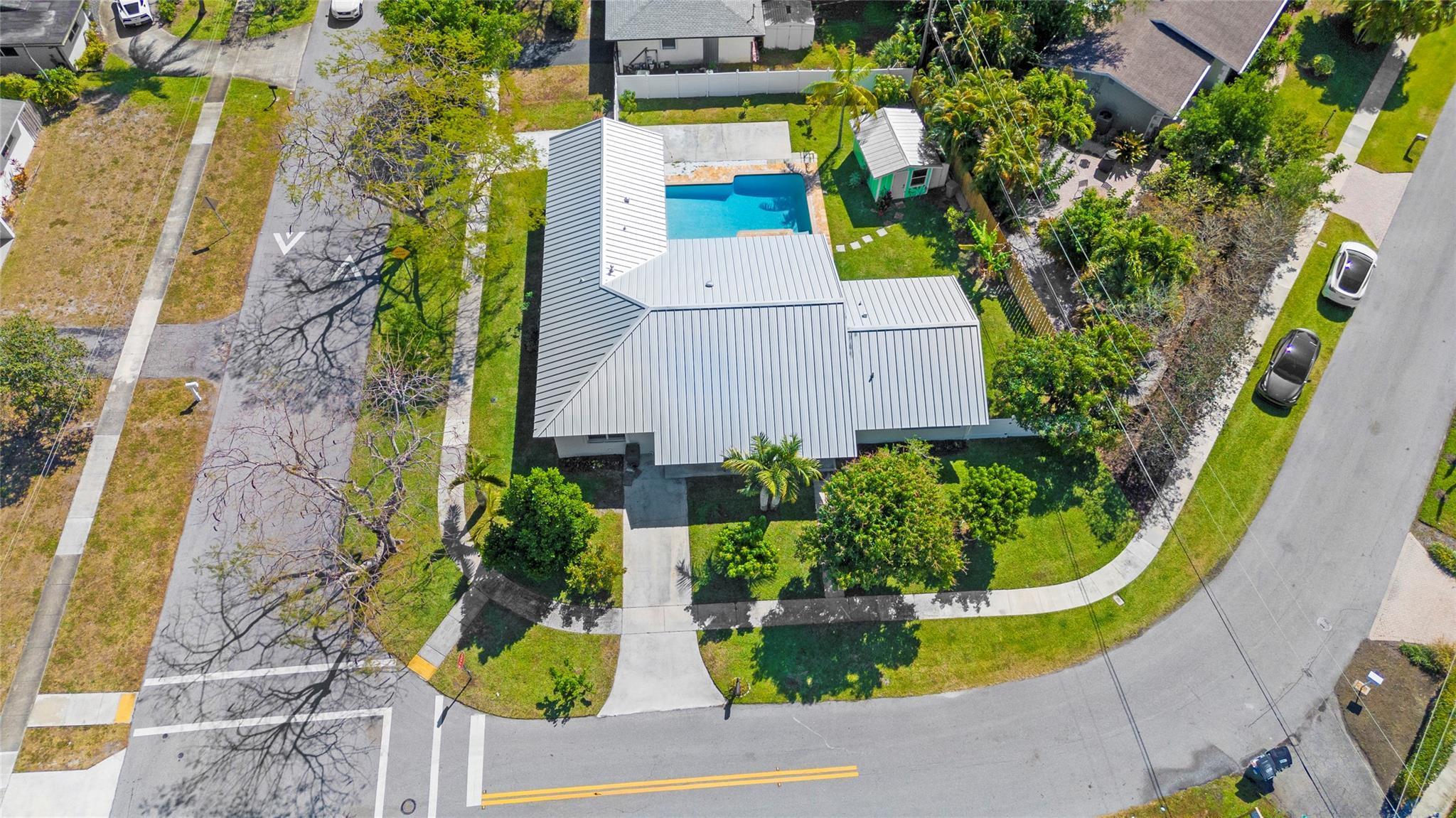This centrally located, top schools, 4 bed and 3 bath corner lot house has new commercial grade medal roof, new fence and pool diamond bright all from 2024. House rebuilt in year 2005 with soaring high ceilings; new LED ceiling lights through out each room. 16 seer Tran A/C from 2019; All windows are protected by accordion shutters plus all west side windows has new impact widows; grand open kitchen with all wood cabinets and granite countertops and gas stove. Freshly painted inside out, Porcelain tiles in the living area, real oak wood flooring in three of the bedrooms, The grand patio is under a real pitched roof, shed storage with a new metal roof from 2020, Tropical mature fruit trees( sour sop, Jack fruit, 4 types of mangoes, Lychee, longan, avocado, banana