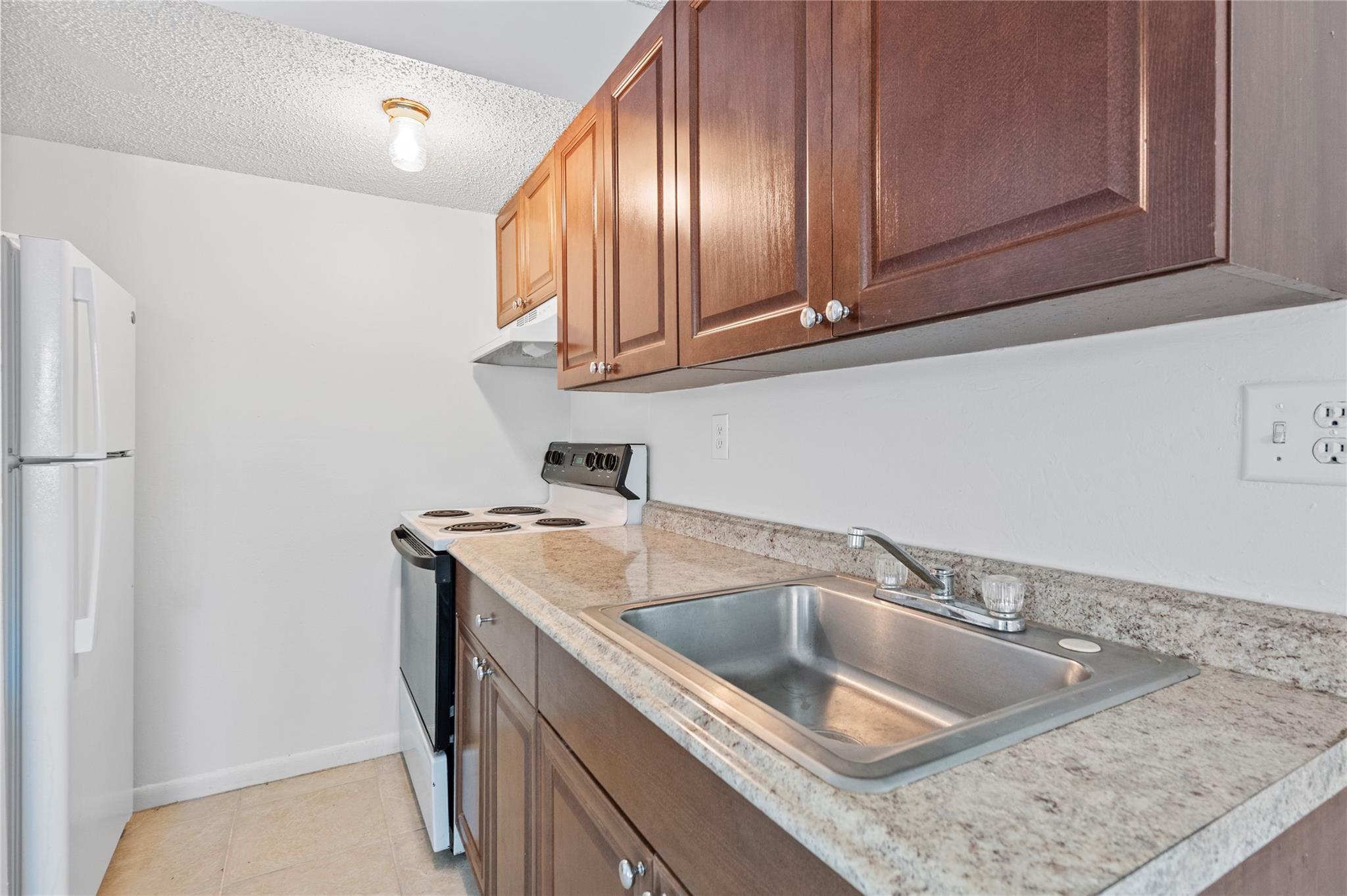 Welcome to this lovely second-floor 1 bedroom, 1 bathroom condo located in the beautifully maintained Hidden Forest community. This bright and airy unit features tile flooring throughout and freshly painted white walls, creating a clean and modern feel. The spacious bedroom includes a large walk-in closet, perfect for your storage needs. Enjoy the convenience of an in-unit washer and dryer for easy everyday living. Community Highlights: well-kept and quiet neighborhood, 1 assigned parking space per unit, plenty of guest parking available. Per association rules: No animals allowed, all ages welcome.