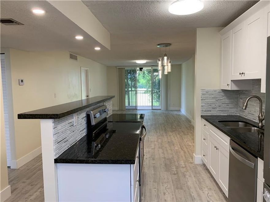 RARE FIND! COMPLETELY REMODELED! AMAZING VIEW TO GOLF COURSE AND LAKE! KITCHEN WITH NEW WOOD CABINETS,GRANITE COUNTER TOPS, NEW HI-END WHIRLPOOL APPLIANCES, REFRIGERATOR FEATURING FILTERED ICE AND WATER. OVERSIZED GREAT-ROOM AND DESIGNER LIGHTING. LOCATED ON THE EXCLUSIVE JACARANDA GOLF AND COUNTRY CLUB IN A VERY PEACEFUL ENVIRONMENT. INCLUDED IS A LAUNDRY FACILITY WITH NEW APPLIANCES AND RECHARGEABLE CARD SYSTEM, STORAGE ROOM, HEATED COMMUNITY POOL, RECREATION ROOM AVAILABLE FOR PARTIES. AC IS 2024. GREAT FOR INVESTORS. UNIT IS RENTED TO GREAT TENANTS