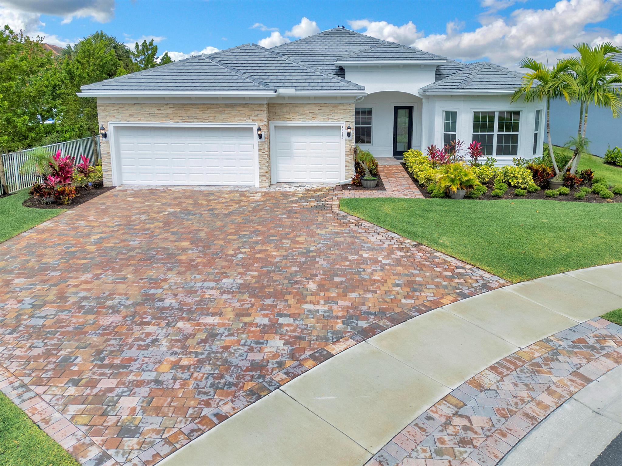 Experience luxury living in Windsong Estates, gated community in Lake Worth, designed with a focus on contemporary comfort and convenience. Just minutes from the Florida Turnpike and close to the vibrant attractions of Wellington, this community offers a perfect blend of tranquility and accessibility. This 'Stellar' model, built in 2022, is a standout one-story home featuring 3 bedrooms+2 flex rooms, 3 bathrooms, a 3-car garage, dramatic high ceilings, and an added sunroom that enhances the spacious feel. The home also includes a covered and screened lanai that looks out onto a beautiful, private water lot situated on a quiet cul-de-sac.