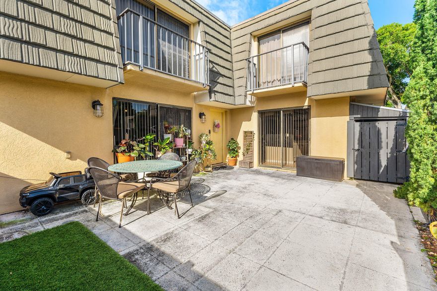 Discover this beautifully maintained 2BR/2.5BA DiVosta-built townhome in the sought-after Village of Sandalwood Lakes. This popular floor plan features dual primary suites upstairs, each with a private en-suite bath, walk-in closet, and balcony. The bright main level offers an open living area, guest half-bath, and indoor laundry.  Enjoy your morning coffee in the oversized, fully fenced private courtyard—perfect for pets and outdoor entertaining. Residents enjoy resort-style amenities: 3 pools, tennis, pickleball, and fitness trails. Low-maintenance living as the HOA covers water, cable, roof, and exterior insurance. Located minutes from Tanger Outlets, PBI Airport, and downtown. Living in Villages of Palm Beach Lakes offers the ultimate South Florida lifestyle!