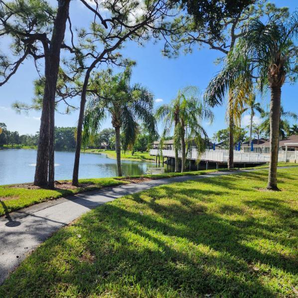Beautiful 55+, renovated 2nd floor condo. Open floor plan with light tones and wood flooring. Full size washer & dryer inside unit! Both bedrooms have walk in closet. Well maintained and in excellent condition. Accordion Hurricane Shutters throughout.Vevy well kept community. Minutes from shopping and restaurants. Community offers a pool on a lake, shuffleboard, Bocce, clubhouse.