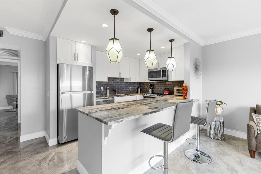 WOW! GORGEOUS 1 BEDROOM, 1.5 BATH CONDO LOCATED IN THE DESIRABLE GRANTHAM AREA OF CENTURY VILLAGE! THIS STUNNING HOME FEATURES AN OPEN KITCHEN WITH GRANITE COUNTERTOPS, STAINLESS STEEL APPLIANCES, WHITE CABINETRY AND ELEGANT PENDANT LIGHTING. XL PORCELAIN TILE ON THE DIAGONAL FLOWS SEEMLESSLY THROUGHOUT.  THE PRIMARY BATHROOOM SHOWCASES A PEBBLESTONE FLOOR WITH FLOOR TO CEILING TILE AND SLEEK GLASS DOORS. YOUR BACK PATIO BOASTS AN EXPANSIVE GREEN SPACE VIEW-THE PERFECT SPOT TO RELAX AND UNWIND.  ENJOY STYLISH, MODERN LIVING IN ONE OF THE MOST SOUGHT AFTER SECTIONS OF THE VILLAGE.  CENTURY VILLAGE HAS RESORT STYLE AMENITIES TO INCLUDE A THEATER, INDOOR AND OUTDOOR POOLS, PICKLEBALL, TENNIS, RESTAURANT, COURTESY SHUTTLE AND SO MUCH MORE! ASSOCIATION CLAIMS 55+