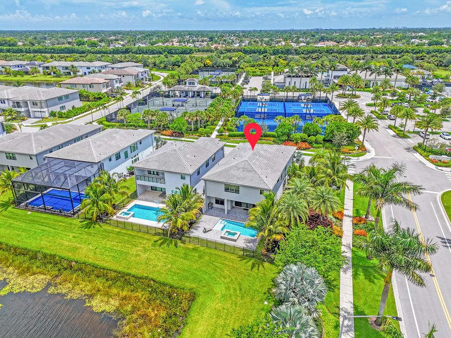 Luxury lakefront living in the prestigious Lotus community less than a one-minute walk to the Lotus clubhouse, offering resort-style pools, cafÃ© and restaurant, fitness center with classes, tennis and pickleball, children's playrooms, and work/lounge spaces. This Polynesia model sits on a rare corner lakefront lot with private pool and jacuzzi and ideal east-west exposure. Interior features include soaring ceilings, a wall of windows, Italian porcelain floors, and abundant natural light. Chef's kitchen with gas range and premium finishes. Additional highlights include a primary suite with dual baths, loft, first-floor in-law suite, cabana bath, and $180K+ in upgrades.