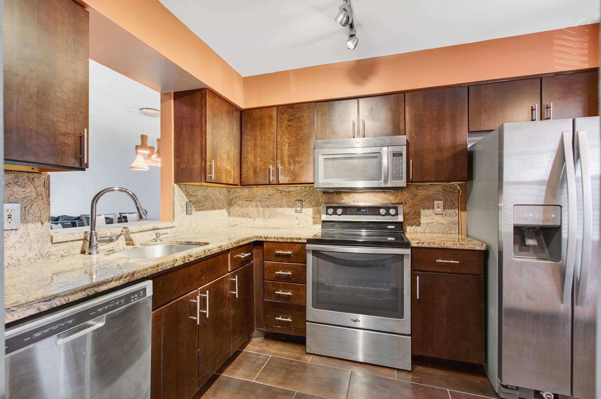 HUNTINGTON LAKES--ACTIVE ADULT COMMUNITY, 55+ community. Introducing the highly sought-after residence at 7290 Kinghurst Drive, Unit 405, located in Section 5 of the vibrant and prestigious Adult Community of Huntington Lakes. Section 5--Rentable from Day 1 after purchase. Fantastic opportunity for investors.Elevated on the fourth floor, this remarkable property boasts a peaceful lakeside setting, offering serene views that feel like a personal retreat.An inviting promise of warmth reverberates throughout the unit, amplified by pleasing wood floors. The accommodation is tied together with a meticulously planned layout that emphasizes comfort and privacy, with subtly partitioned bedrooms.