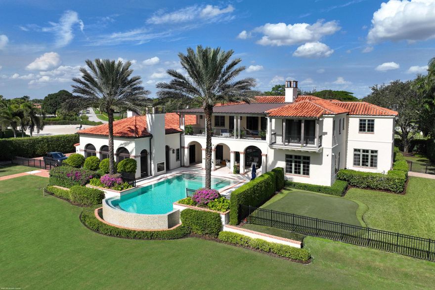 A true masterpiece!  Unmatched equestrian estate positioned next to Wellington International horse show grounds.  Mere minutes walking to the competition arenas. The main home and owners barn were constructed with the highest quality and finest design.  A standing work or art!  
This Mediterranean style equestrian compound boasts Palm Beach Island level finishes and spans over 4 acres across two lots and includes an exquisite, 11,359 sq ft (7878 sq ft under air), 5-bedroom plus office main residence with a guest apartment, two 8-stall barns, a 3-bedroom staff apartment, an oversized NEW, sub-irrigated riding arena that measures 210x125ft, a grand prix field and 10 paddocks. A rare opportunity to own one of the finest equestrian estate in Wellington. Designed by architect Roger Janssen, the main home features elegant living and dining spaces, a billiards room, office, screened porch, butler's kitchen and well-appointed kitchen and family areas. Upstairs hosts the primary suite and three additional bedrooms. Premium finishes include cypress ceilings, custom cabinetry, hardwood flooring, a full-house generator, Infinity pool overlooking the field and much more.