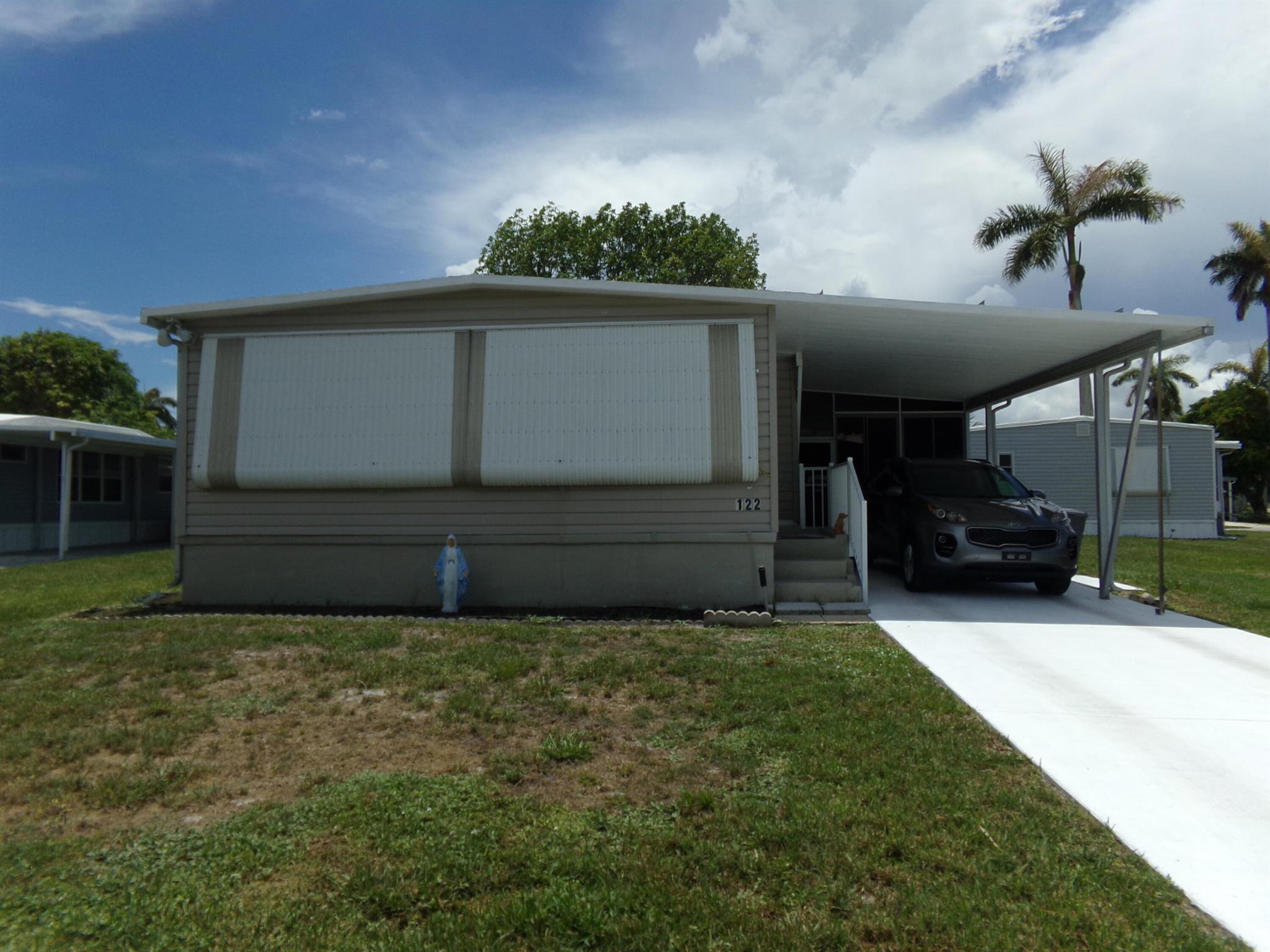 Affordable living in desirable Palm Beach County! 55+ community in Colonial Estates is where this well maintained manufactured home is located. It is a 2 bedroom, 2 bath with plenty of storage space and closets. An enclosed sunroom adds to the living space. Also has screened in patio as well. Situated on a nice size corner lot, where there is no land lease! Low monthly hoa of 250 per month that includes lawn care, cable, trash removal and water. taxes are also very low. Whether you are a snowbird or looking to be full time, this home is priced to sell and includes all furniture and is turnkey. The community has a pool , community room, and shuffleboard.