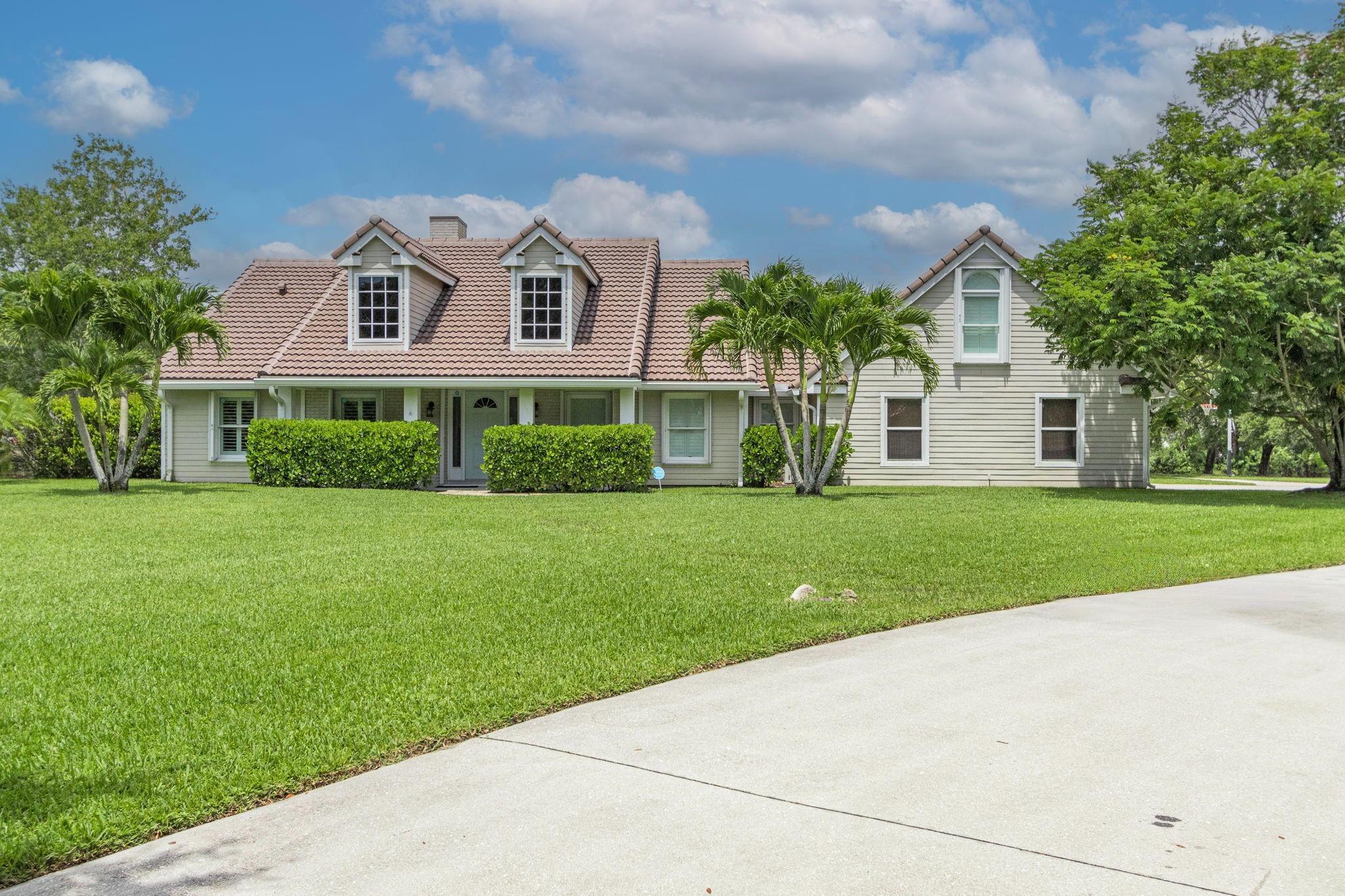 Beautiful custom home on over an acre in gated Lago Del Sol. Ideally located just 14 miles from Palm Beach International Airport, under 5 miles to The Mall at Wellington Green, and only a few minutes from Wellington International -- home of the world-famous Winter Equestrian Festival. Approximately 30 minutes from the white sand beaches of Palm Beach and close to major outlets and dining.This spacious property offers 4 bedrooms, 2.5 bathrooms, and two private upstairs flex rooms -- perfect for guests, remote work, or hobbies. Enjoy a renovated kitchen, new roof, canal views, pool, and a 6-car garage layout. Peaceful, private, and move-in ready