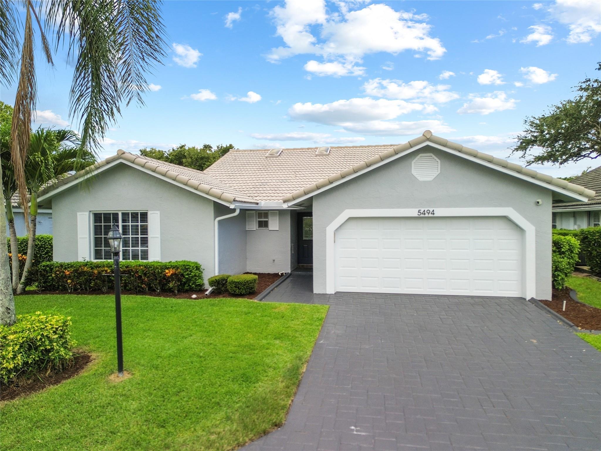 Gorgeous & Completely Renovated 3BR/2BA home in the highly sought-after Pine Ridge Villas, a quiet community in North Central Coral Springs. Features an open floor plan with vaulted ceilings, updated flooring, fresh interior/exterior paint, two large skylights that flood the home with natural light. Enjoy a brand-new modern eat-in kitchen, with Quartz Countertops, 2 renovated bathrooms, and impact windows throughout. Spacious primary suite includes a walk-in closet and spa-style bathroom. Enclosed patio, 2-car garage, new A/C (2025), and water heater (2019). Low HOA of $590/quarter covers landscaping, sprinklers, and community pool. Prime location near top-rated schools, major highways, parks, shopping, & dining. Move-in ready with upgrades throughout—this is Florida living at its best!