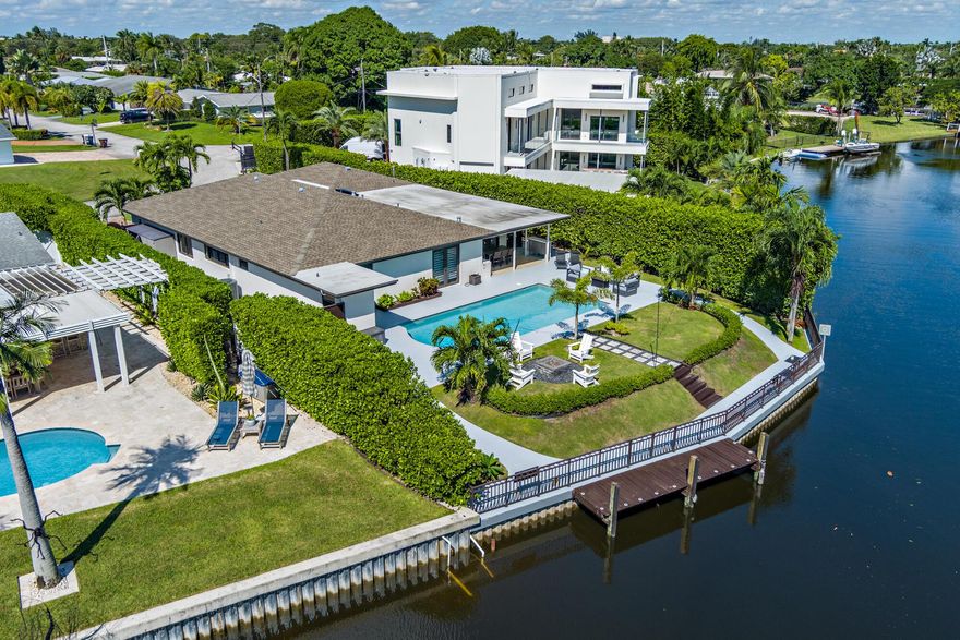 One-of-a-Kind Waterfront Retreat in Lake Clarke Shores. Discover the perfect blend of privacy, comfort, and South Florida living in this beautiful 4-bedroom, 3-bathroom pool home with a 2-car garage, ideally situated on a unique canal-front lot in the highly sought-after community of Lake Clarke Shores.Tucked away on a quiet, low-traffic street, this residence feels like your own private waterfront retreat. Enjoy serene views and direct access from your backyard with seawall and private dock -- perfect for relaxing, entertaining, or watching sunsets by the water.The home features: A large, recently renovated swimming pool. An outdoor kitchen with natural gas. Newer roof. Two spacious living areas offering flexibility and comfort. This home sits on an on an 10,200 ft. lot, off