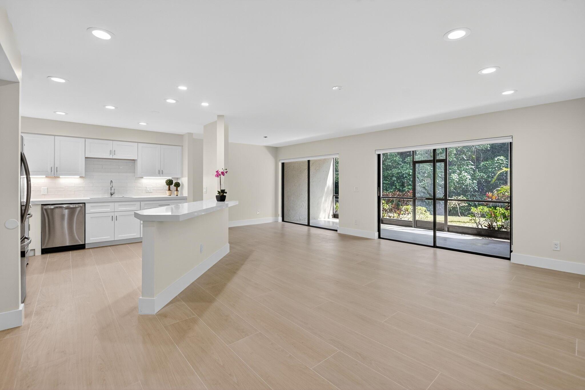 Stunning totally renovated first floor residence situated on a tranquil and peaceful preserve setting. Gorgeous finishes include a modern contemporary open kitchen a boasting quartz center island with dual sided breakfast bar, custom white cabinets w/soft close doors/drawers, quartz countertops and new SS appliances. Bright open living area with LED high-hats and smooth white ceilings. Beautiful wide plank porcelain tile throughout. Primary offers preserve views, two closets and sliders to the patio. Beautiful updated bath with white quartz top vanity, walk-in shower and seamless glass door. Generous tiled screened patio adds outdoor living space to relax, dine al-fresco and entertain. 1CG plus storage room. Fee includes cable, water, roof, insurance, pools & landscaping. A must see!
