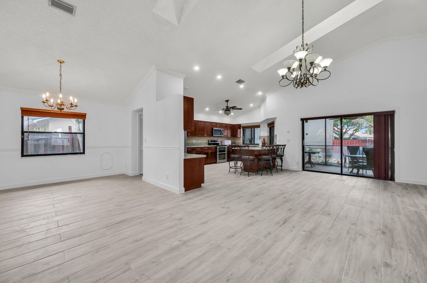 Welcome to Silver Woods in Boca Raton. This updated home is located in a non-HOA community = rapid approvals. This open concept home features brand new porcelain tile floors throughout, large living areas, high ceilings, granite countertop kitchen, modern bathrooms, two-car garage and is full of natural sunlight. Enjoy the covered patio and fully fenced large backyard. Quick access to major roads, all things shopping, houses of worship, dining and more.