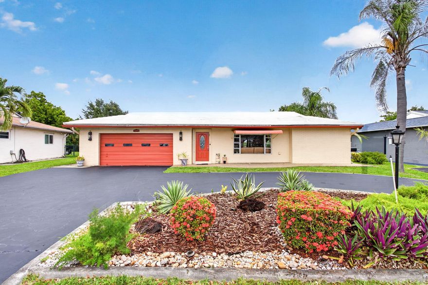 WOW!! You found the perfect house-3 bedroom split plan, 2 remodeled baths, family room, theater room, 2 car garage, circular driveway, spacious fenced lot, breathtaking wide lake waterfront, oversized-covered screened patio in a highly desirable community with clubhouse & community pool! Enjoy a beautifully updated kitchen with pass-through into the family room-featuring granite, wood cabinets, stainless appliances-stunning! Nice home office area that some place a breakfast table just off the kitchen. Enjoy a TV viewing room that can also be a 4th bedroom. Spacious owner suite has a walk-in closet as well as a built-in wall closet.  Remodeled master bath features classy dual sink vanity, spa-like shower & beautiful tile. Pretty guest bath has a relaxing soaking tub-very soothing. Hurry!