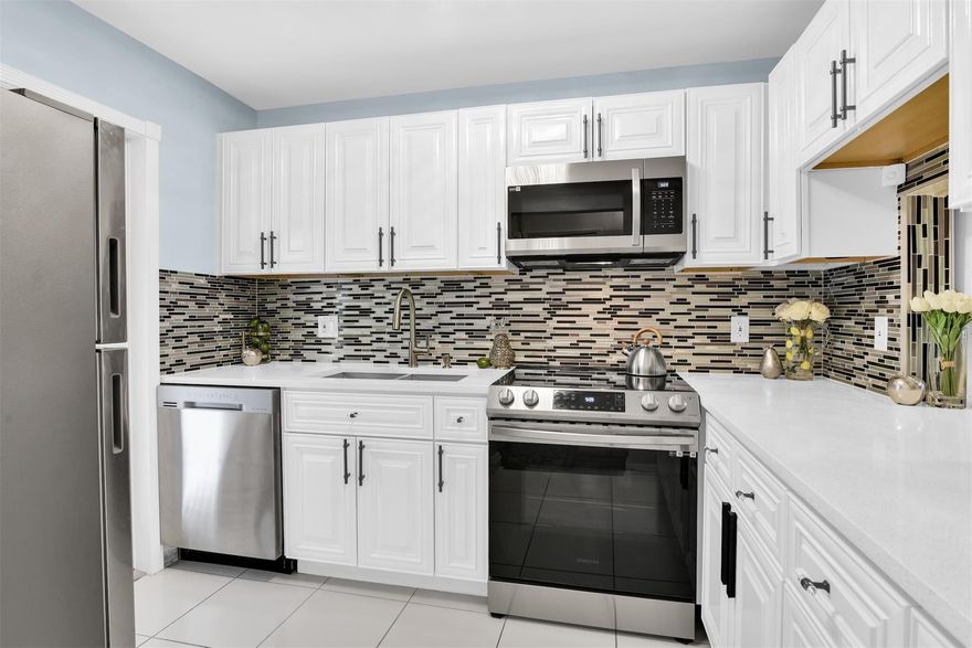 WELCOME TO 2 BEDROOM, 2 BATH UNIT FEATURES IMPACT WINDOWS AND DOOR. WHITE KITCHEN CABINETS, QUARTZ COUNTERTOPS, TILE BACKSPLASH, SS APPLIANCES. SPACIOUS DINING AND LIVING ROOM WITH SLIDING DOORS TO BALCONY OVERLOOKS CLUBHOUSE AND GARDEN. LARGE MASTER BEDROOM  FEATURES A WALK-IN CLOSET, PLANTATION SHUTTERS AND BEAUTIFUL BATHROOM. THE 2ND BEDROOM FEATURES A WALK-IN CLOSET AND PLANTATION SHUTTERS TOO. BEAUTIFUL 2ND WASHROOM.  FRESHLY PAINTED. NEW WATERPROOF LAMINATE FLORING. NEW LED LIGHTS AND 4 FANS THROUGH. NEW ELECTRIC PANEL. EXTRA STORAGE, LAUNDRY ROOM AND ELEVATOR NEXT TO THE UNIT. ASSIGNED PARKING SPACE N72. THIS 55+PLUS COMMUNITY HAS CLUBHOUSE, HEATED POOL, BBQ GRILLS, BOCCE BALL AND MUCH MORE. NO LEASING. NO PETS. CLOSE TO SHOPPINGS, PUBLIX, BANKS, RESTAURANTS, LIBRARY AND BEACH! New cooling tower system is installed in 2022 for lower FPL bill.
