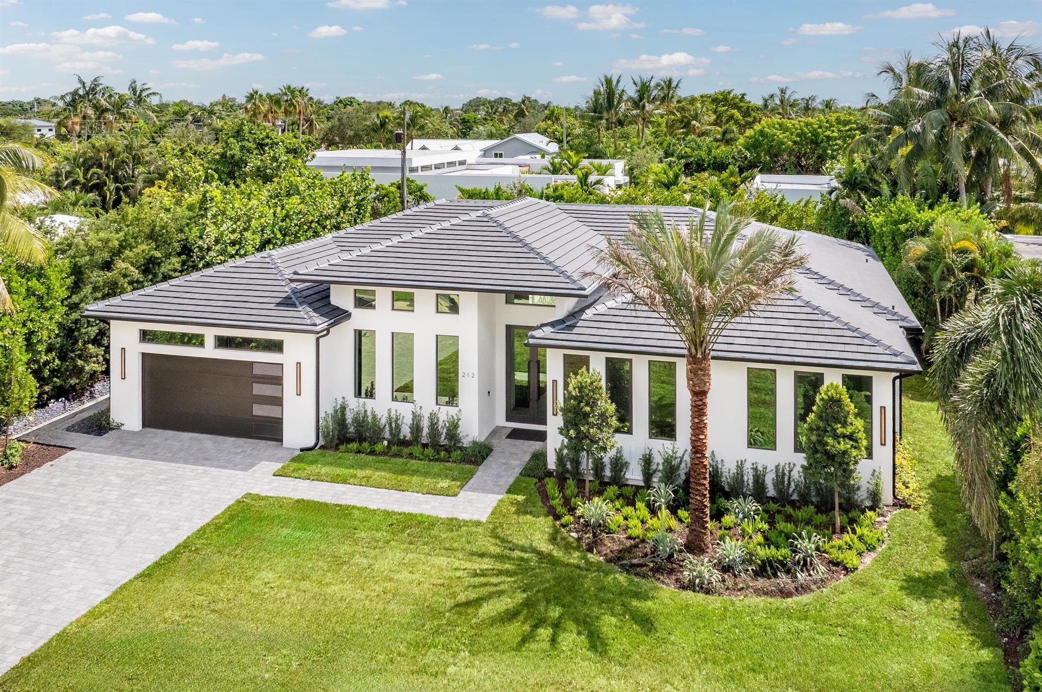 Luxury coastal living has never been more inviting in East Delray Beach. This modern-style, brand-new construction residence offers the highest quality finishes paired with a thoughtful floor plan. This elegant Lake Ida home is a turnkey gem, with 4 bedrooms and 4.5 baths across 5,079 +/- total square feet, 4,350 +/- of which are under air.Impeccably designed interiors and lushly landscaped exteriors create the perfect backdrop for living and entertaining. The open-concept layout is elevated with 10-inch wide plank engineered oak flooring and dramatic ceiling details with hidden shade pockets and LED cove lighting.