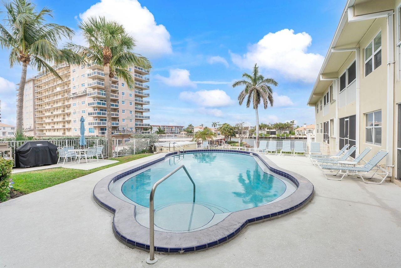 Motivated Seller! Enjoy the paradise lifestyle, just steps from the beach with private deeded beach access! Located off Hillsboro Mile, sidewalks to enjoy daily walks and beautiful sunrises and sunsets. 2 story condo building boosts a heated community pool, extra storage locker comes with unit and views of the Intercoastal. Updated 2 bedroom,2 full bath condo is located on the first floor. New lightening fixtures, washer and dryer in unit, pet friendly and view of the heated community pool. This condo has new hurricane doors, hurricane windows, screened in patio with solar shade for privacy. The A/C was replaced in 2024, the Water Heater is from 2025, Reasonable HOA, Roof covered by HOA is from 2022 and inside just painted and has been through the 40 year recertification.