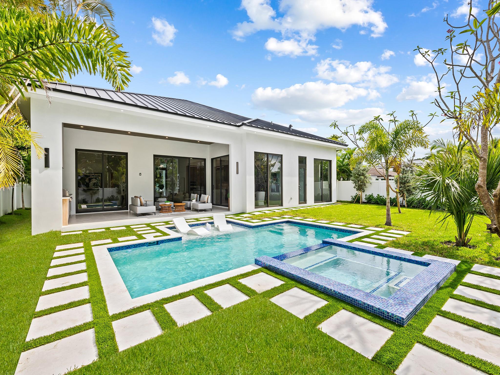 NEW CONSTRUCTION PRICED TO SELL NOW WITH IMMEDIATE OCCUPANCY | 13’ CEILINGS THRU OUT | 3,588 TOTAL SQ FT. Built by MSK Homes, featuring curated designer finishes & an expansive luminous open concept flr plan. Custom culinary kitchen, enormous walk-in hidden pantry, 12'+ center island. The lrg covered loggia boasts an outdoor summer kitchen w/marine-grade Lioher cabinetry & luxurious counter tops. Floor to ceiling walls of glass showcase & open onto the pool/spa & waterfall framed by tropical landscaping. The Primary suite offers an oversized custom WIC with island & spa inspired bathroom with Kohler Anthem system. Glass walled office, cabana bath, laundry rm, architectural LED tray ceilings, Italian porcelain flooring, speaker system, high mount garage, no flood zone. Sq ft from architect.