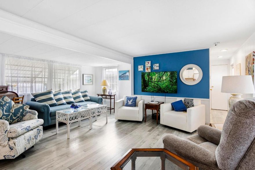 Welcome to your perfect winter retreat. Nestled at the end of a quiet cul-de-sac, this charming 2-bedroom, 2-bath completely furnished home sits on a private lot surrounded by plenty of peaceful green space. Secluded and serene, it's an ideal escape for relaxing. Enter through the oversized screened-in patio, perfect for morning coffee or evening breezes, and step through the glass front door into a light-filled, open living space. The spacious living room, dining area, and kitchen flow together beautifully, creating an airy and welcoming atmosphere. The split bedroom layout offers privacy, with one bedroom and full bath just off the kitchen, and a generously sized primary bedroom off the living room featuring bay windows and ample closet space. The remodeled bathroom includes a convenient step-in shower.  Laminate flooring runs throughout the home, no carpet, adding to the clean, low-maintenance appeal. Enjoy Florida's sunshine from your open patio area.  A large shed houses the washer and dryer and provides extra storage. A true hidden gem with a private lot, this sunny winter getaway is ready to be enjoyed.  Sold completely Furnished with everything you need. Enjoy Florida living in this gated community with plenty of activities, 2 heated pools, pickleball courts, shuffleboard, billiards, library and so much more.  Low monthly fee includes water, sewer, fiber optic internet, lawn care, manager on site and an array of activities.  Located close to dining, shopping and the local beaches.