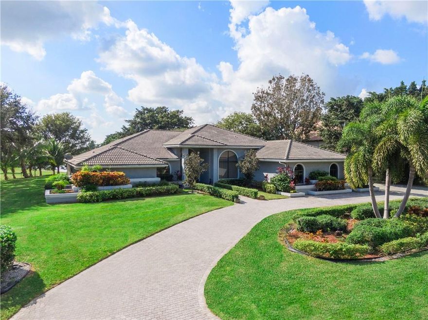 SEE VIDEOGRAPHY.  Stunning Renovated Contemporary Waterfront Home on Large Lot With Serene Long Lake Views. No expense spared. Extraordinary interior architectural transformation. Huge open flr plan-direct lake views, light colored floors/high ceilings, jaw-dropping kitchen. Kitchen is center stage: fine white European cabinetry, massive double island, double wine fridge/ovens, large “hidden” pantry, countertops waterfall edge. High end fixtures/appliances. Split floor plan/great flow. 4 Bedrooms/1 used as media room; 3 baths; office; 3 car; screened pool. Hurricane impact windows/doors. Expansive main suite: large walk-in California closet; spa bath/soaking tub/separate shower.  Media room/ insulated walls. Fitness, heated resort pool, playground, tennis, walking paths. Gated/Security.