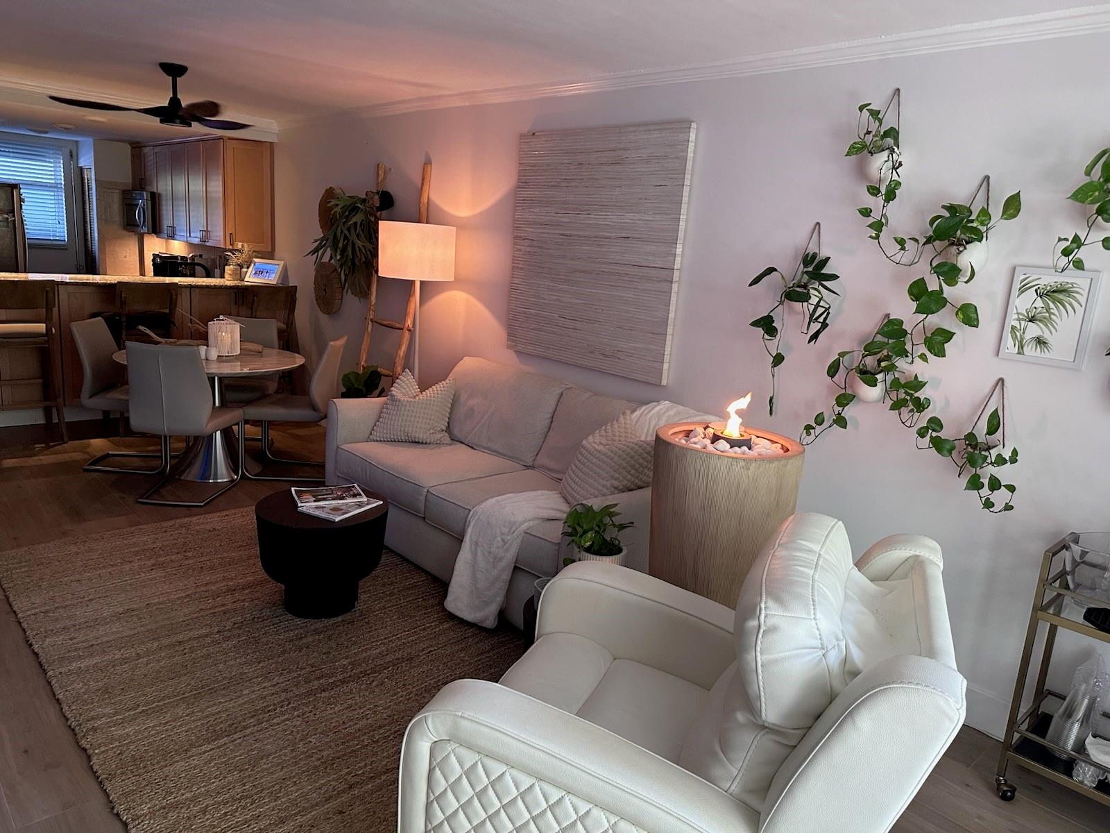 Welcome to this first floor tranquil oasis, a chic living space where every detail is designed to evoke a sense of calm and serenity. The bedroom feels like a true sanctuary, featuring a breathtaking mural of lush, tropical foliage that brings the outdoors in. The new bathroom has a stunning walk-in shower enclosed by sleek glass door, while the walls are adorned with chic, subway tiles in a beautiful earthy green tone.
The cozy screened in patio is the perfect spot to unwind and enjoy the tropical view. Open the patio door and just steps away you'll find a stunning waterfall, a lush courtyard with lagoons, pool, tiki bar and grills. Many updates including impact windows and sliding door, hurricane shutters, new wood floors, new closets, double doors in the master bedroom.