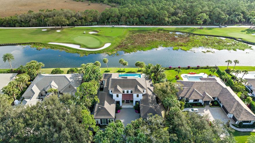 Nestled within the gated golf community of Old Marsh Golf Club, this 2019 custom built estate boasts expansive water, golf and preserve views.  The architectural detail paired with the interior design appointments captures a stately yet welcoming residence.  Mature oaks framing the entry drive to a motor court surrounded by garages for 4+ cars, one complete with a lift for the auto enthusiast and ceiling heights allowing for additional lifts.  A beautiful front elevation with white brick detail, copper gutters and stunning, painted mahogany entry doors, welcomes you to one of the finest settings in Palm Beach Country.  The foyer with oak flooring laid in a herring bone pattern leads to a formal living area with fireplace, sliding glass doors opening to a spacious outdoor living area..more