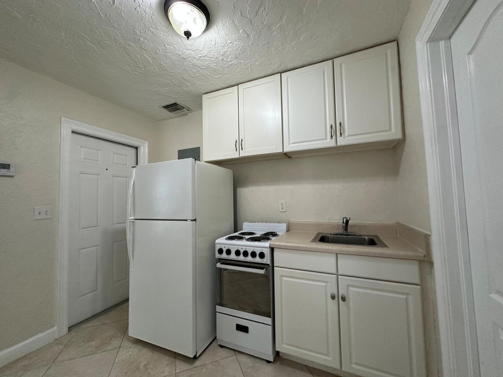 Photo of 227 FORESTERIA Drive #D, Lake Park, FL 33403 (MLS # B26077022)