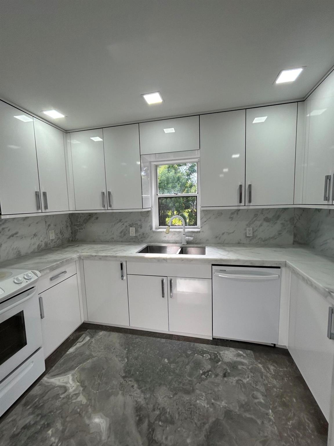 Welcome to this highly upgraded townhome with stunning decor including marble island and flooring throughout! A gorgeous modern kitchen featuring quartzite, newer appliances, and updated bathrooms! Magnificent tiled open patio (courtyard) including a covered area with outdoor cabinets and sink.Located in Beautiful Central Boca Raton with fabulous schools, shopping and dining all close by. Easy commute to I-95, Turnpike and Sawgrass Expressway. All dimensions approximate.