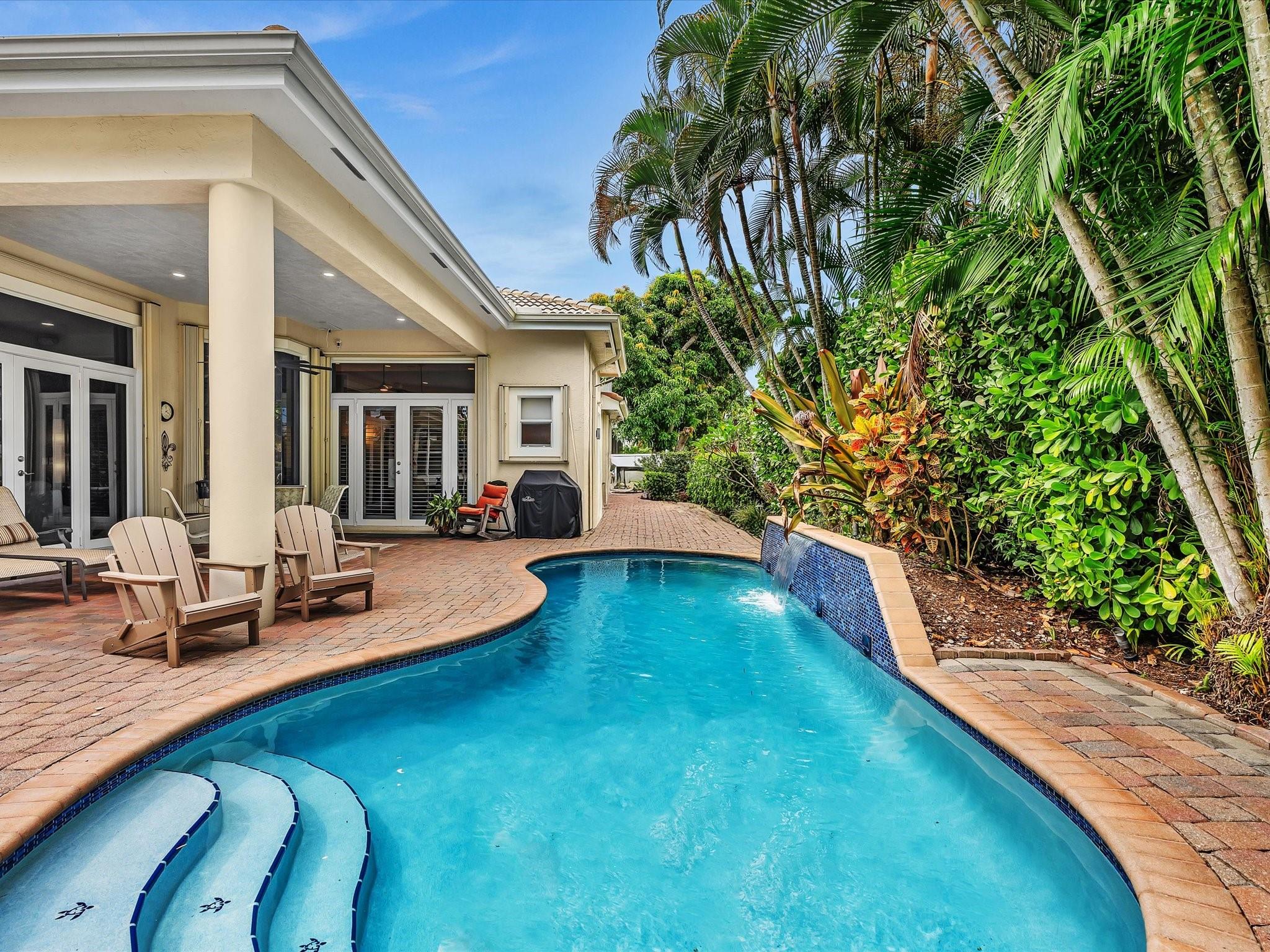 Hidden in sought-after Turtle Run Estates, this exceptional corner-lot home impresses with elegant glass double doors, large porcelain diamond-pattern floors, & recessed LED lighting. The kitchen features stainless steel appliances, wraparound bullnose-edge black granite countertops, breakfast bar, & bright white wood cabinets. Master baths include sandy marble-style tile, frameless glass showers, large porcelain tubs, and newer vanities. Built by a craftsman using quality commercial-grade materials & thick flame-retardant attic insulation, this home is built to last. The accordion shutters throughout & tasteful mix of plantation & banded blinds just adds to privacy & protection. The backyard oasis offers a heated saltwater pool with lit waterfall, covered patio, fencing & 8' Clusia hedge.