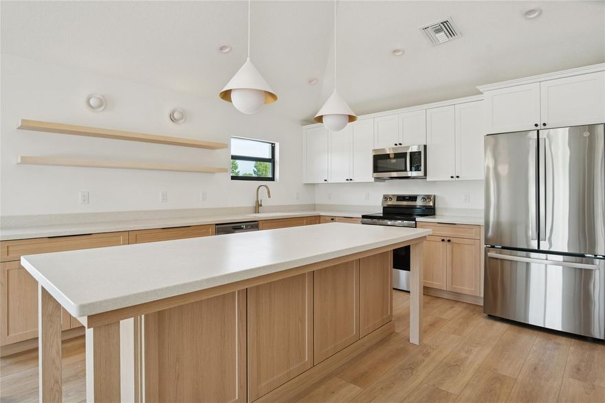 Thoughtfully designed new construction completed in 2026, this 3-bedroom, 2-bath residence offers refined living in a quiet Port Salerno enclave surrounded by Sea Branch Preserve State Park. The open living area features vaulted ceilings, a premium eat-in kitchen with a large island and expansive storage, complemented by professionally curated interiors & designer finishes.Set on an 8,400-square-foot corner lot with preserve views, the property enjoys exceptional positioning, natural light, & openness. Impact windows & doors, a two-car garage, & modern construction standards provide low-maintenance peace of mind. The lot offers room for a future 15’×30’ pool. Ideally located 2-minutes to Manatee Marina & boat ramp and Port Salerno dining, with preserve trails outside the home.