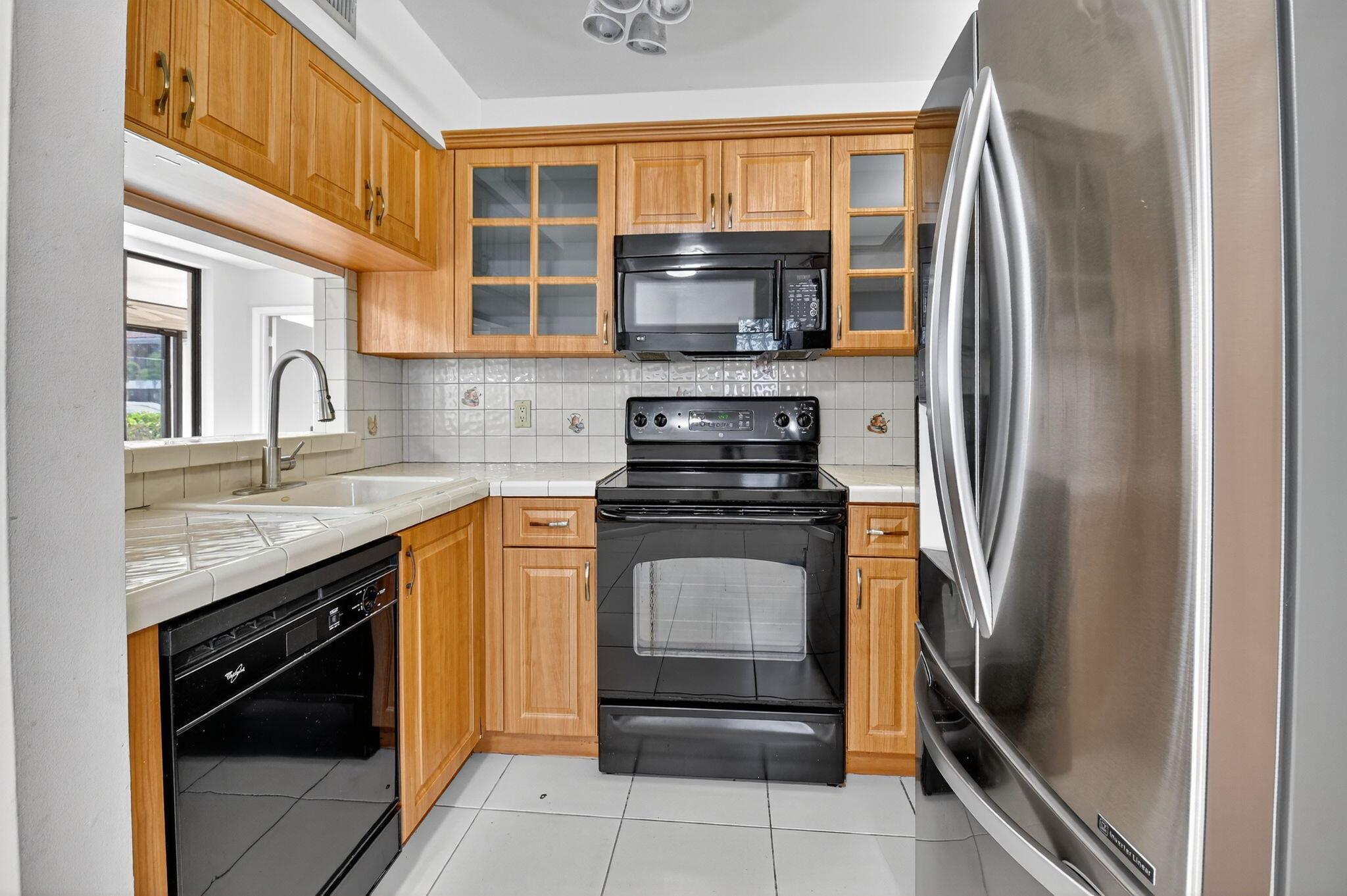 Welcome to this first-floor condo in one of the area's most sought-after communities. Step inside and discover three generous bedrooms and two full bathrooms, offering plenty of space for relaxation or entertaining guests. The eat-in kitchen features newer appliances, abundant cabinetry--including a built-in wine rack--and a handy pass-through to the formal dining area, making meal prep and serving a breeze. Whether you love to cook or simply enjoy a cozy cup of coffee in the morning, this kitchen is sure to please. The virtually staged photos provide inspiration for how you can personalize each living space. Additional amenities include a private storage closet located just outside the front door, perfect for stashing seasonal items or outdoor gear.